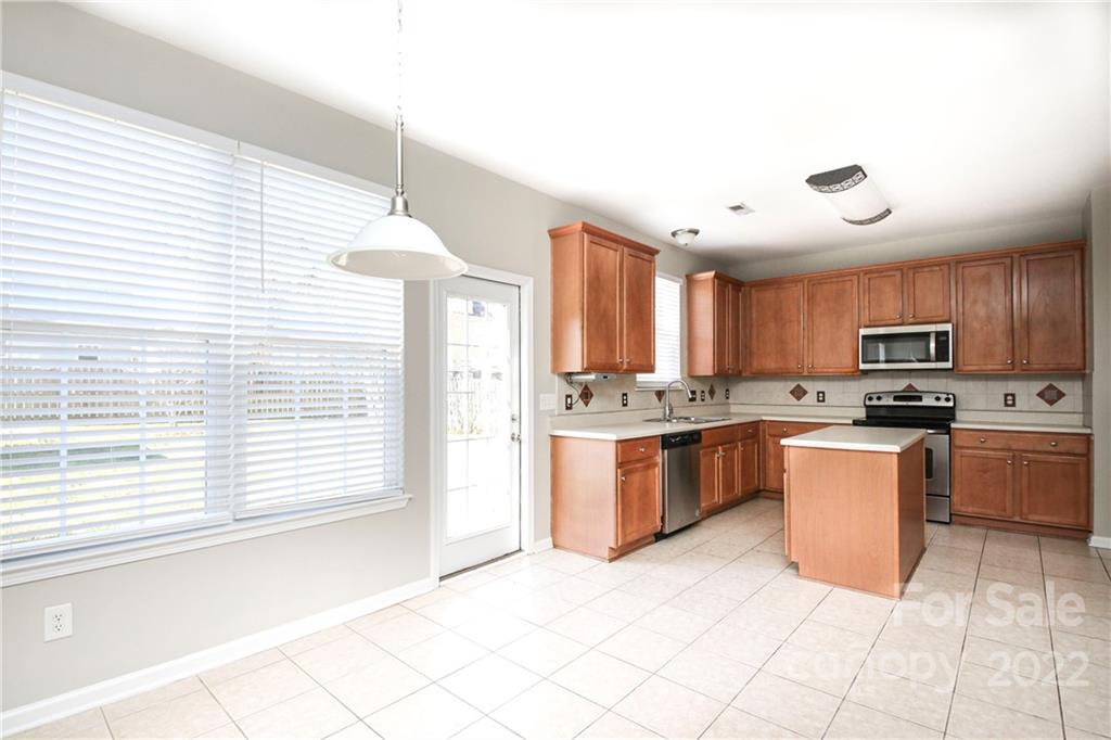 1807 Montague Road, Unit 254 Clover, SC 29710 - Photo 13 of 48 a kitchen with stainless steel appliances granite countertop a stove top oven a sink a counter top space and cabinets