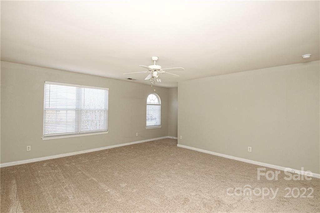 1807 Montague Road, Unit 254 Clover, SC 29710 - Photo 31 of 48 an empty room with chandelier fan and windows