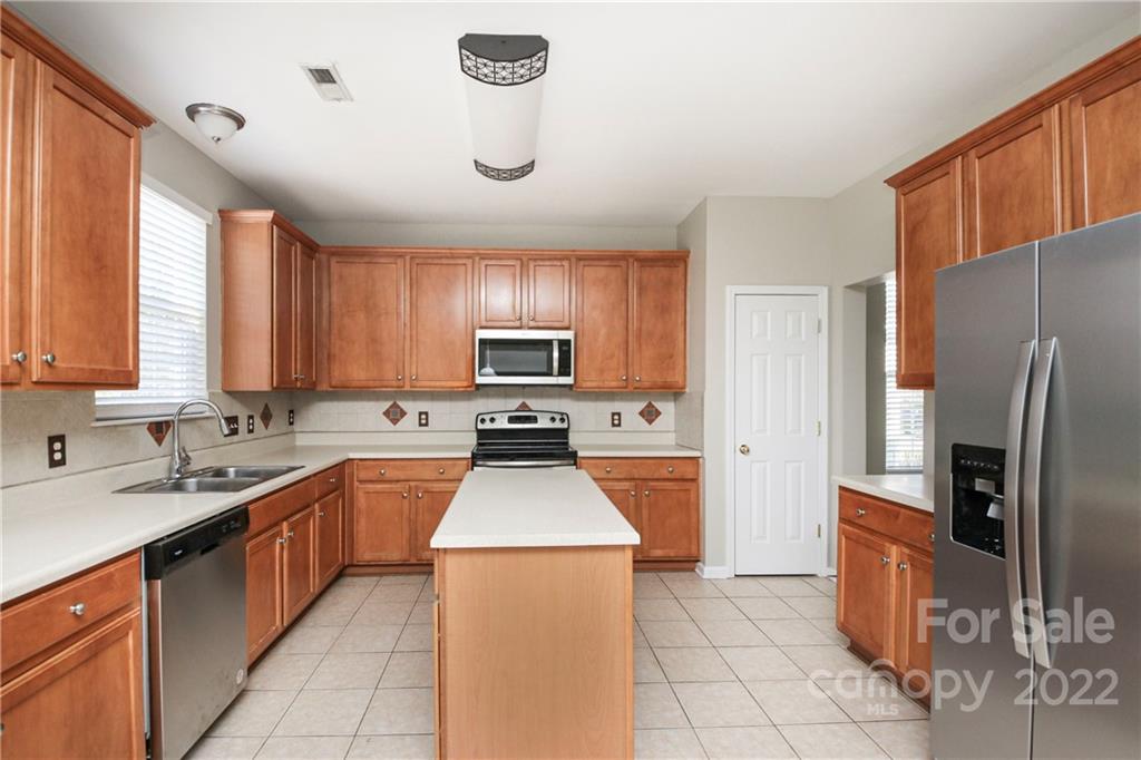 1807 Montague Road, Unit 254 Clover, SC 29710 - Photo 9 of 48 a kitchen with a sink a refrigerator and trees