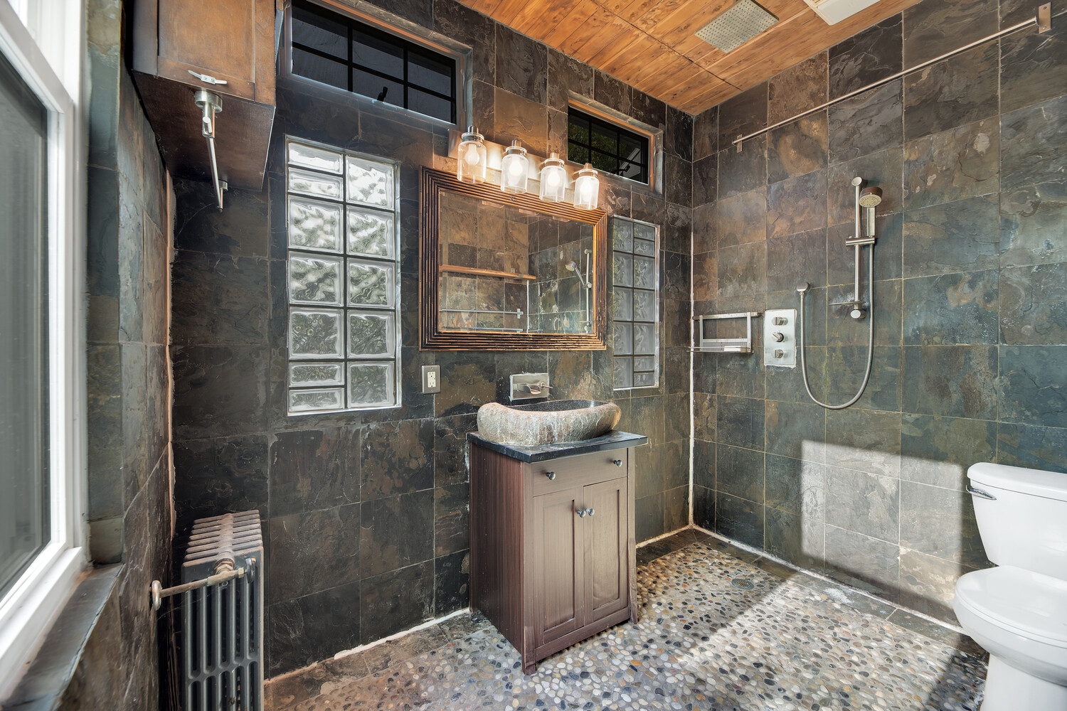 242 Stratford Road Brooklyn, NY 11218 - Photo 11 of 27 a bathroom with a granite countertop sink a toilet and shower