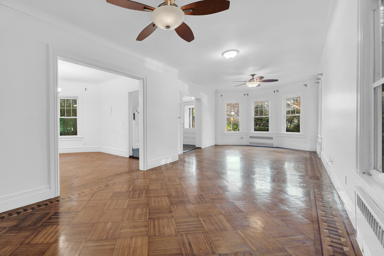 242 Stratford Road Brooklyn, NY 11218 - Photo 3 of 27 a view of an empty room with chandelier fan and kitchen view