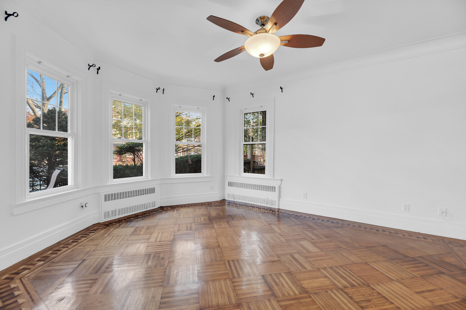 242 Stratford Road Brooklyn, NY 11218 - Photo 4 of 27 an empty room with windows and ceiling fan