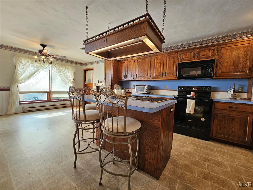 800 Copella Road Bath, PA 18014 - Photo 13 of 43 a kitchen with stainless steel appliances granite countertop a sink a stove a dining table and chairs with wooden floor