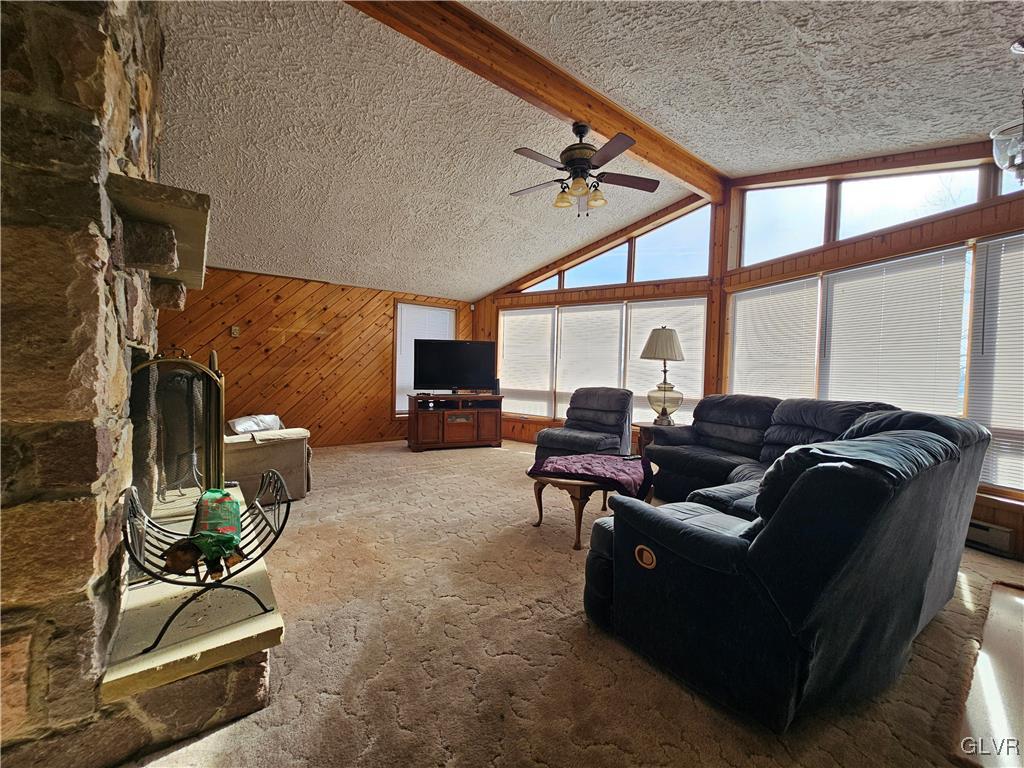 800 Copella Road Bath, PA 18014 - Photo 16 of 43 a living room with furniture a flat screen tv and a floor to ceiling window