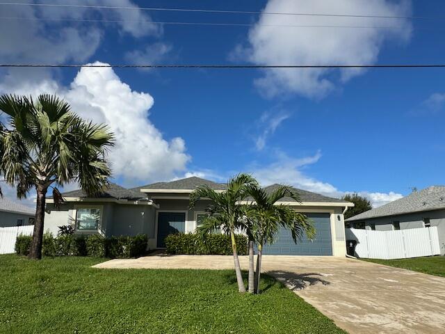 1726 Southwest California Boulevard Port St. Lucie, FL 34953 - Photo 1 of 41 a front view of a house with a yard and potted plants