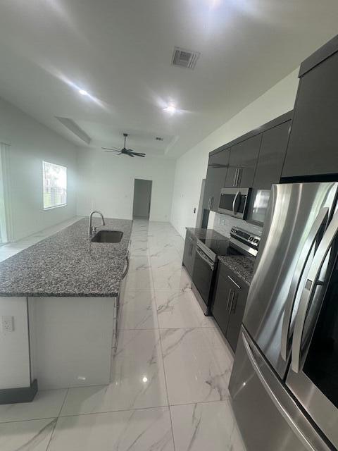 1726 Southwest California Boulevard Port St. Lucie, FL 34953 - Photo 13 of 41 a kitchen with granite countertop a refrigerator and a sink