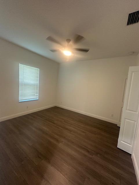 1726 Southwest California Boulevard Port St. Lucie, FL 34953 - Photo 16 of 41 an empty room with wooden floor and windows