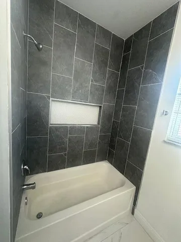 a bath tub sitting next to a shower