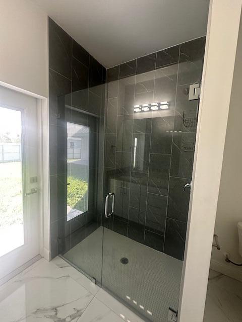 1726 Southwest California Boulevard Port St. Lucie, FL 34953 - Photo 23 of 41 a bathroom with a glass shower door
