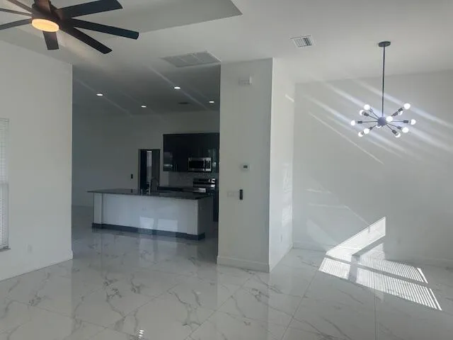 a view of counter top space with furniture and ceiling fan