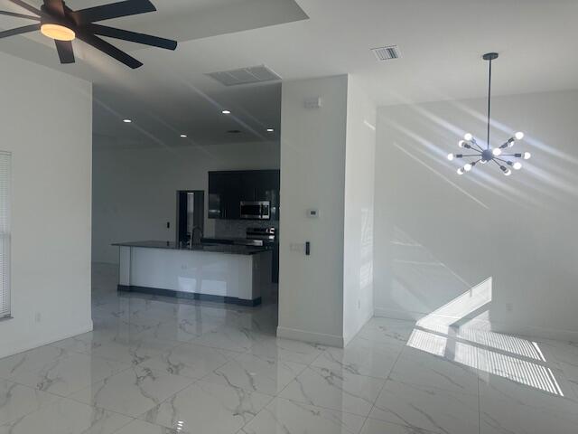 1726 Southwest California Boulevard Port St. Lucie, FL 34953 - Photo 3 of 41 a view of counter top space with furniture and ceiling fan