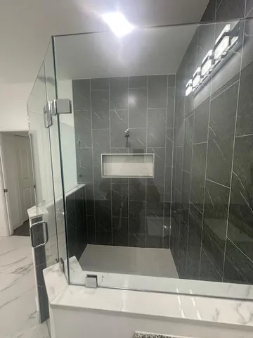 a bathroom with a shower and a sink