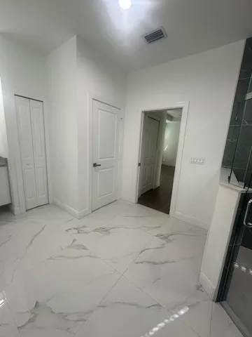 a view of a hallway to rooms