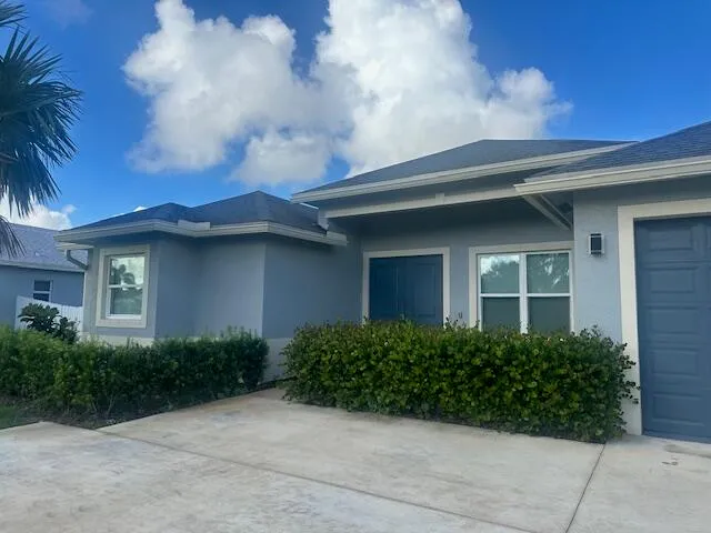 a front view of a house with plants