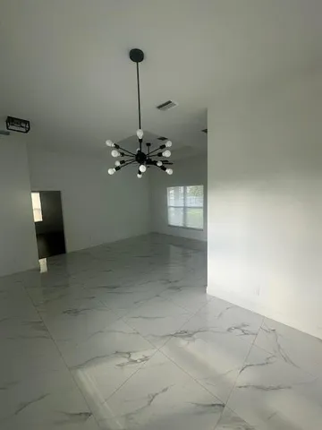 a view of a room with a ceiling fan dryer and washer