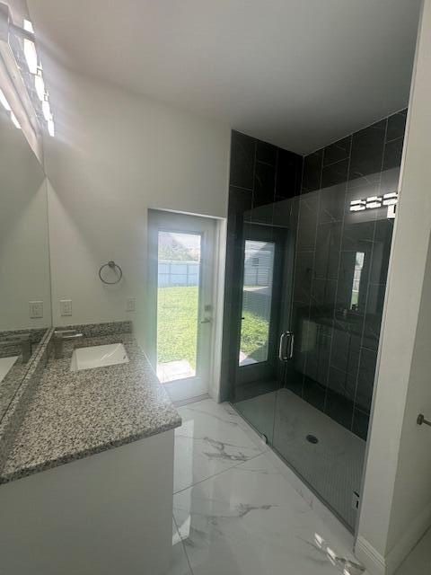 1726 Southwest California Boulevard Port St. Lucie, FL 34953 - Photo 8 of 41 a bathroom with a granite countertop sink a toilet and shower