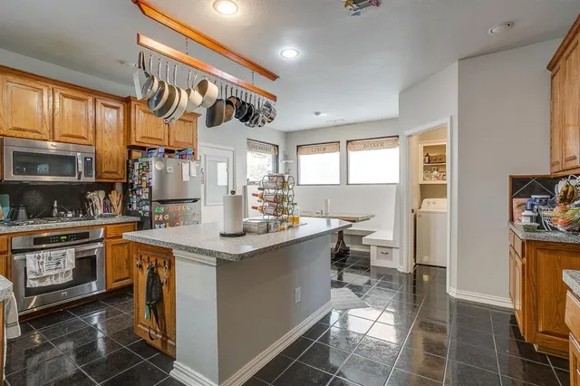 a kitchen with stainless steel appliances a sink and cabinets