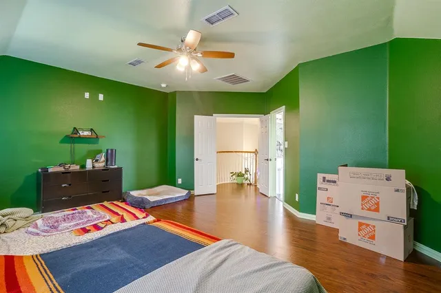 a room with white cabinets and chandelier