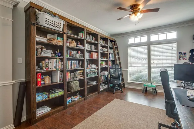 a view of a livingroom with furniture and a bookshelf