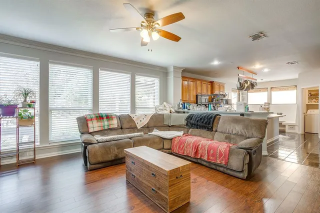 a living room with furniture and wooden floor