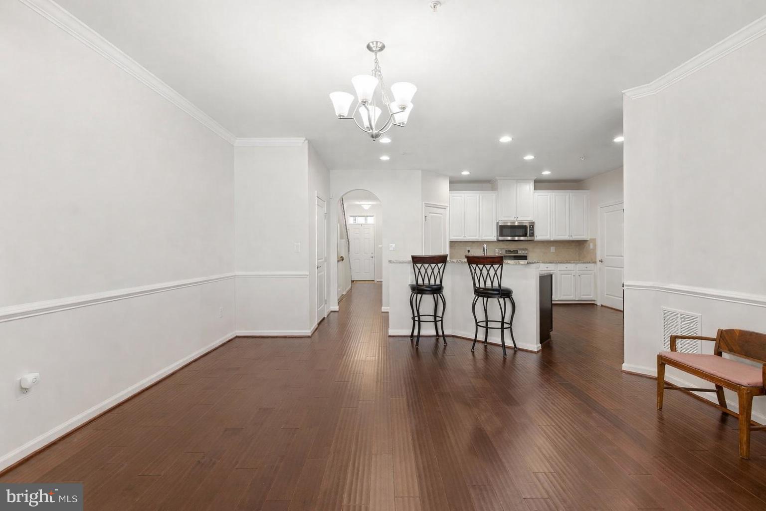 371 Tufton Circle Fallston, MD 21047 - Photo 13 of 47 a view of a kitchen with dining table chairs and wooden floor