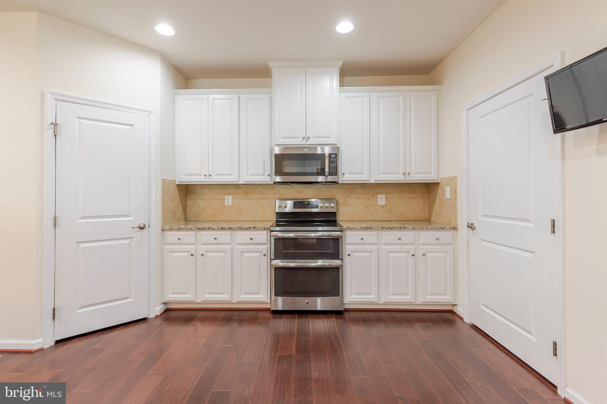 371 Tufton Circle Fallston, MD 21047 - Photo 3 of 47 a kitchen with granite countertop a stove and a refrigerator