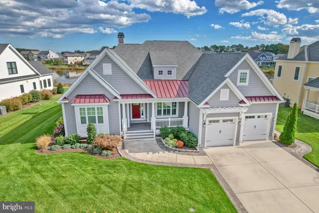 a front view of a house with a garden and plants