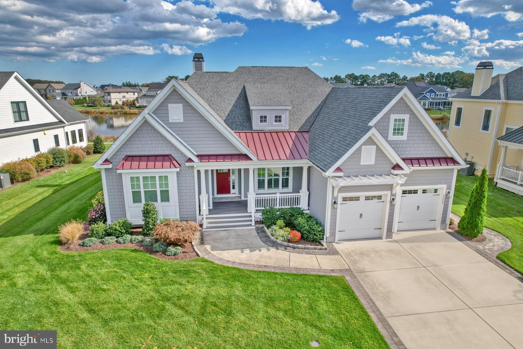 a front view of a house with a garden and plants