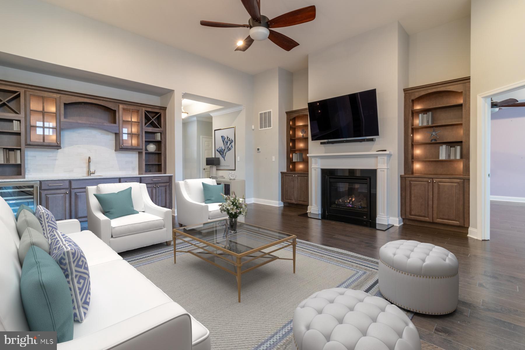36885 Crossrail Way Lewes, DE 19958 - Photo 11 of 70 a living room with furniture a flat screen tv and a fireplace