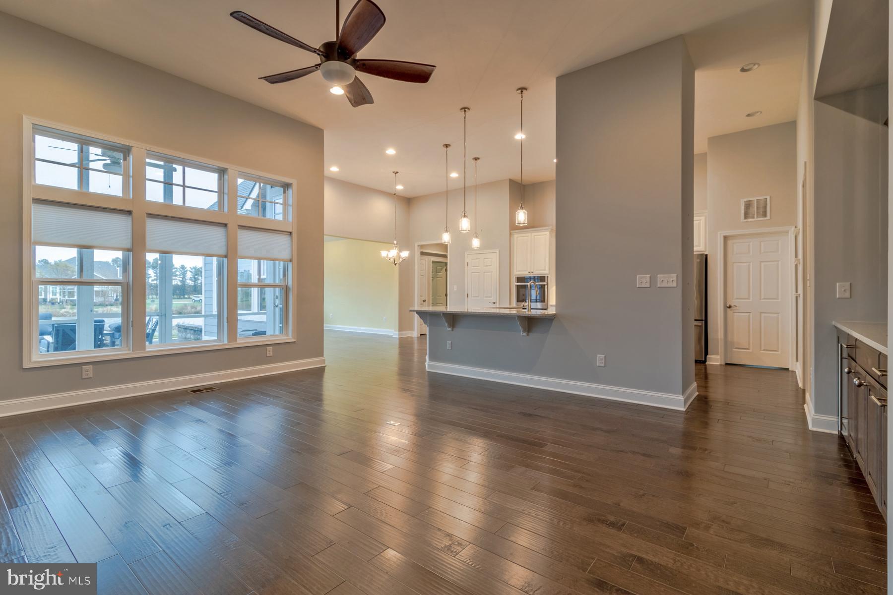 36885 Crossrail Way Lewes, DE 19958 - Photo 12 of 70 a view of an empty room with wooden floor and a window