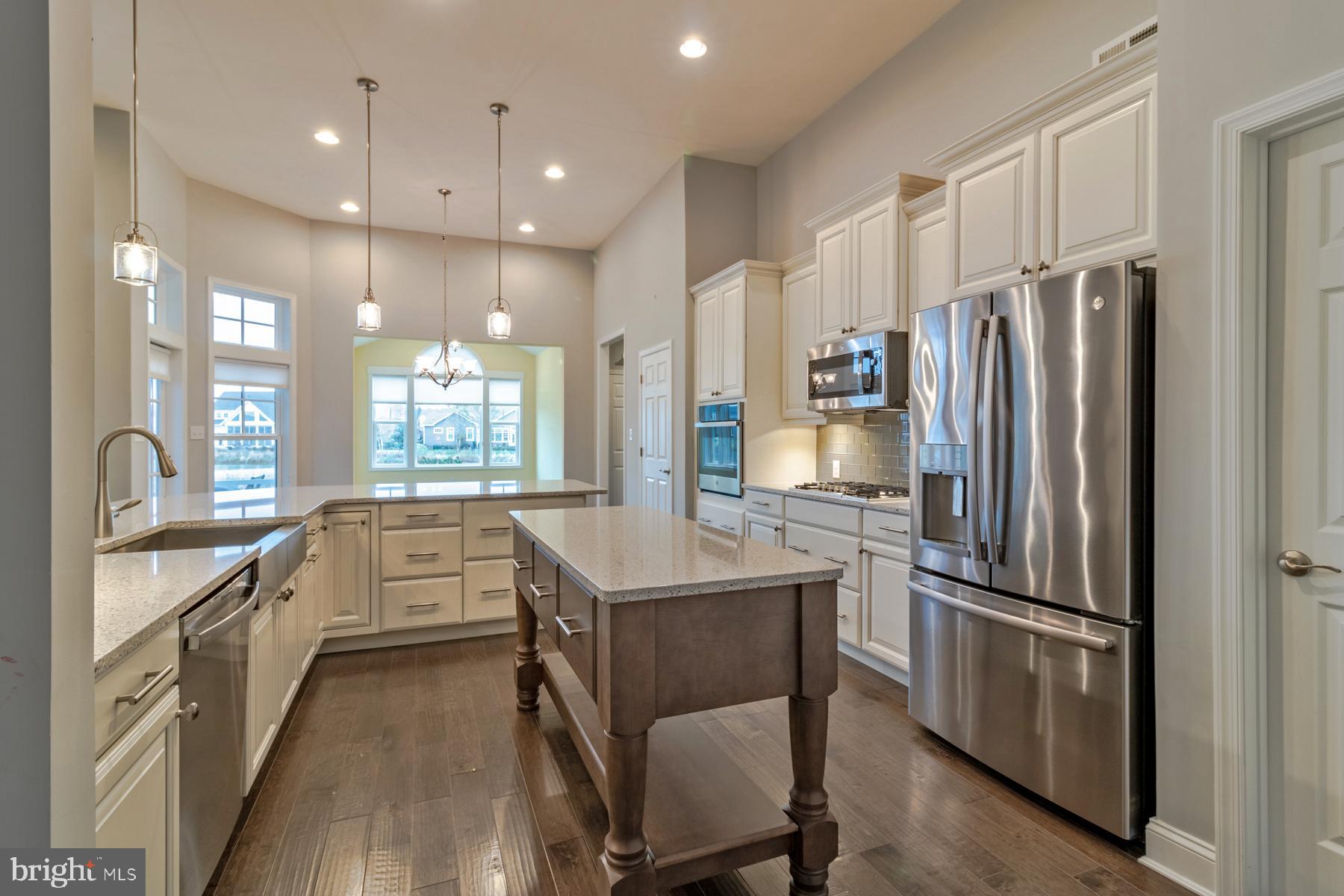 36885 Crossrail Way Lewes, DE 19958 - Photo 17 of 70 a kitchen with counter top space cabinets and stainless steel appliances