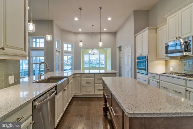 a large kitchen with a table and chairs