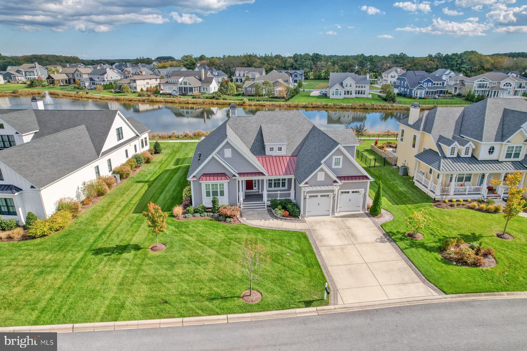 36885 Crossrail Way Lewes, DE 19958 - Photo 2 of 70 an aerial view of a house with a garden and lake view