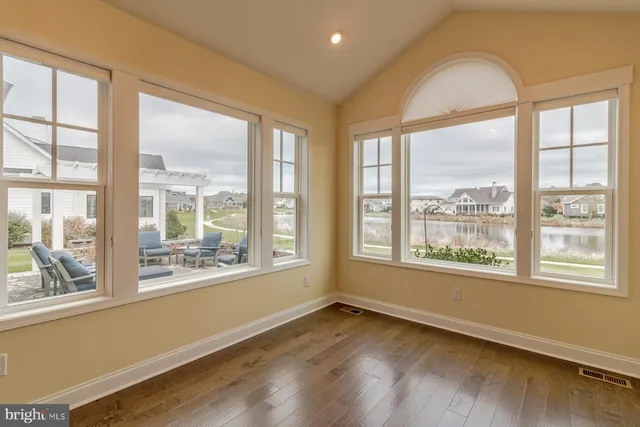 a spacious bedroom with a bed a couch and a large window