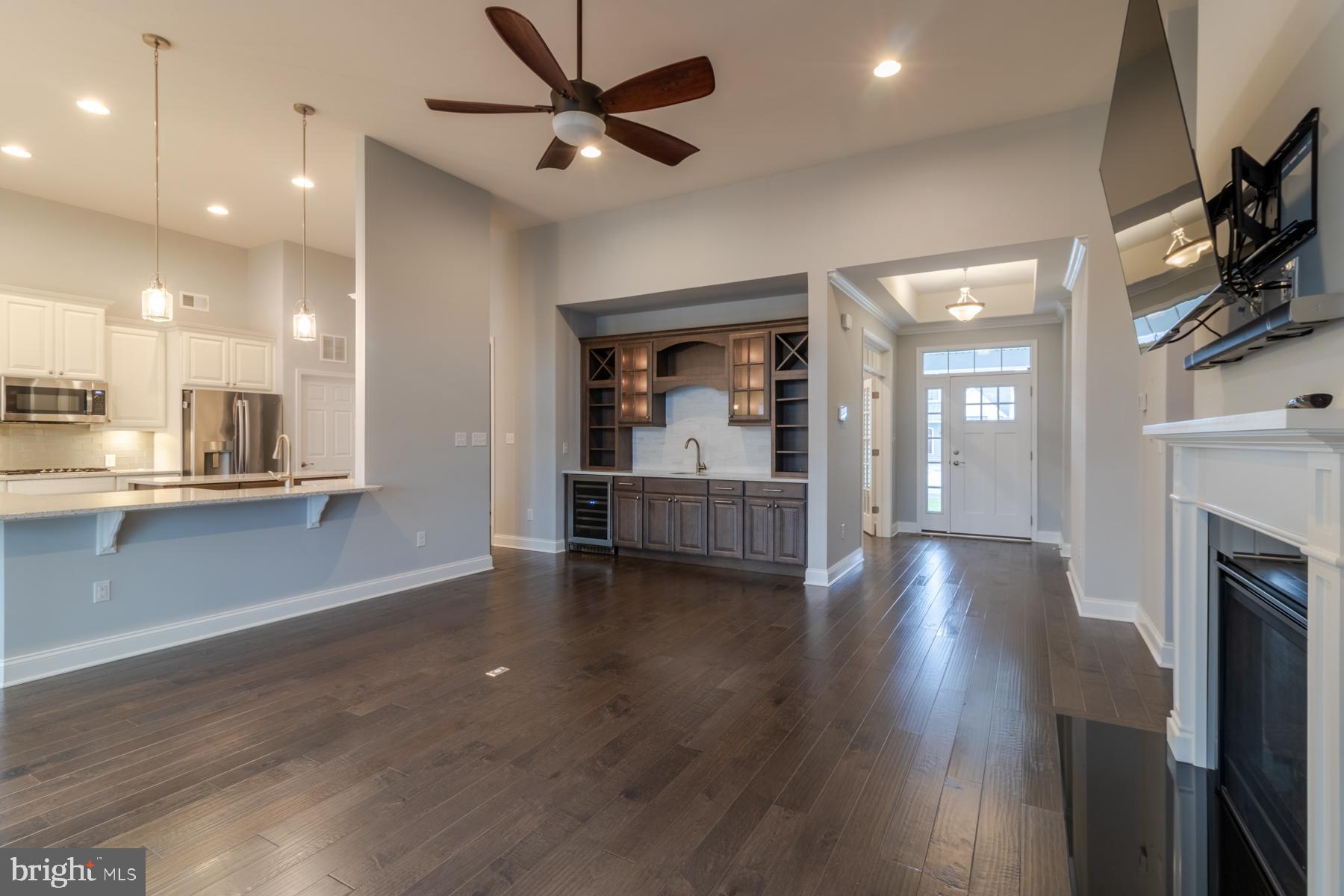 36885 Crossrail Way Lewes, DE 19958 - Photo 8 of 70 a view of empty room with wooden floor and a fireplace