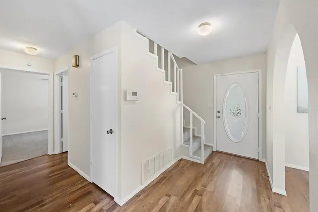 a view of a hallway with wooden floor and entryway