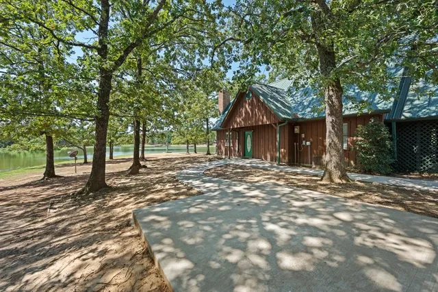 a front view of a house with a tree in front