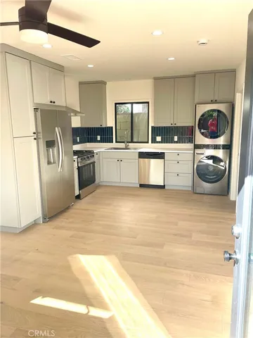 a kitchen with refrigerator and stove