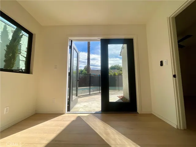 a view of hallway with window and a ceiling fan