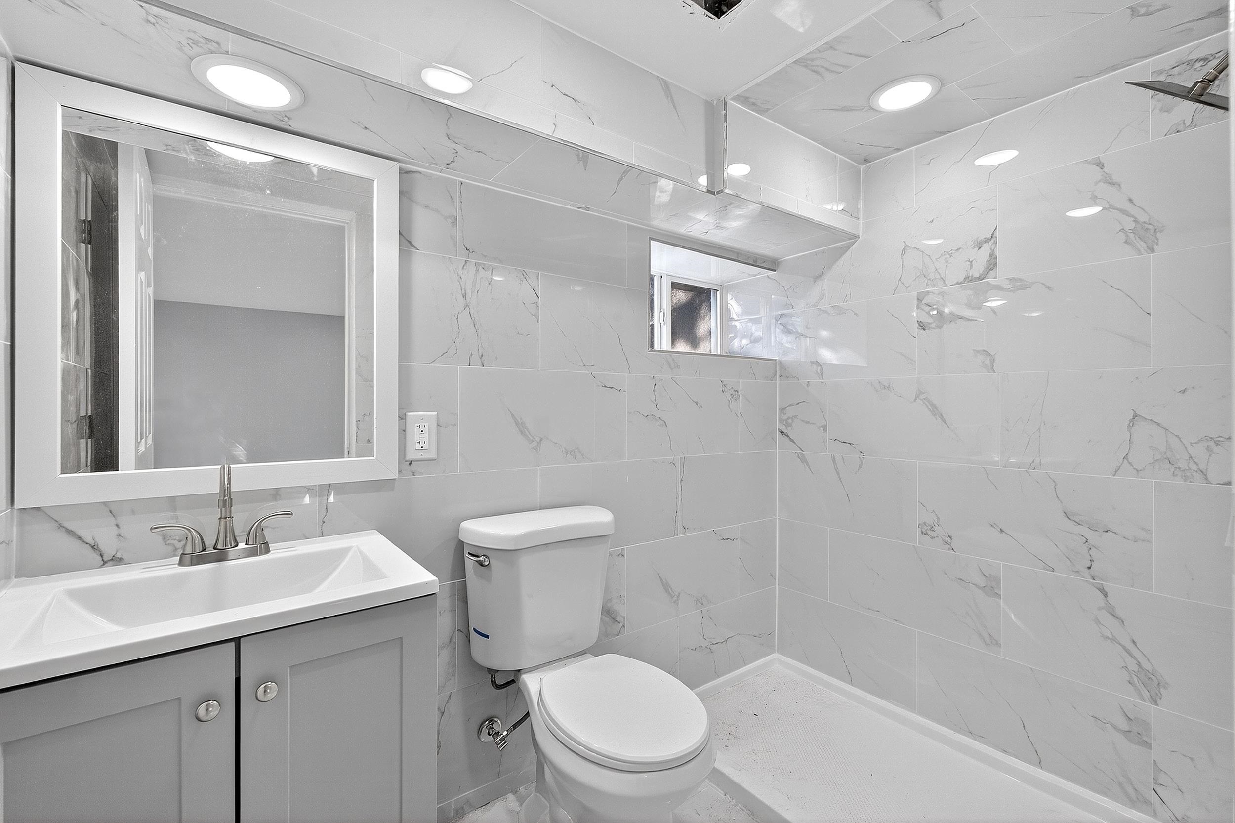 43 Sycamore Road, Unit 1 Jersey City, NJ 07305 - Photo 12 of 15 a bathroom with a sink a toilet and shower