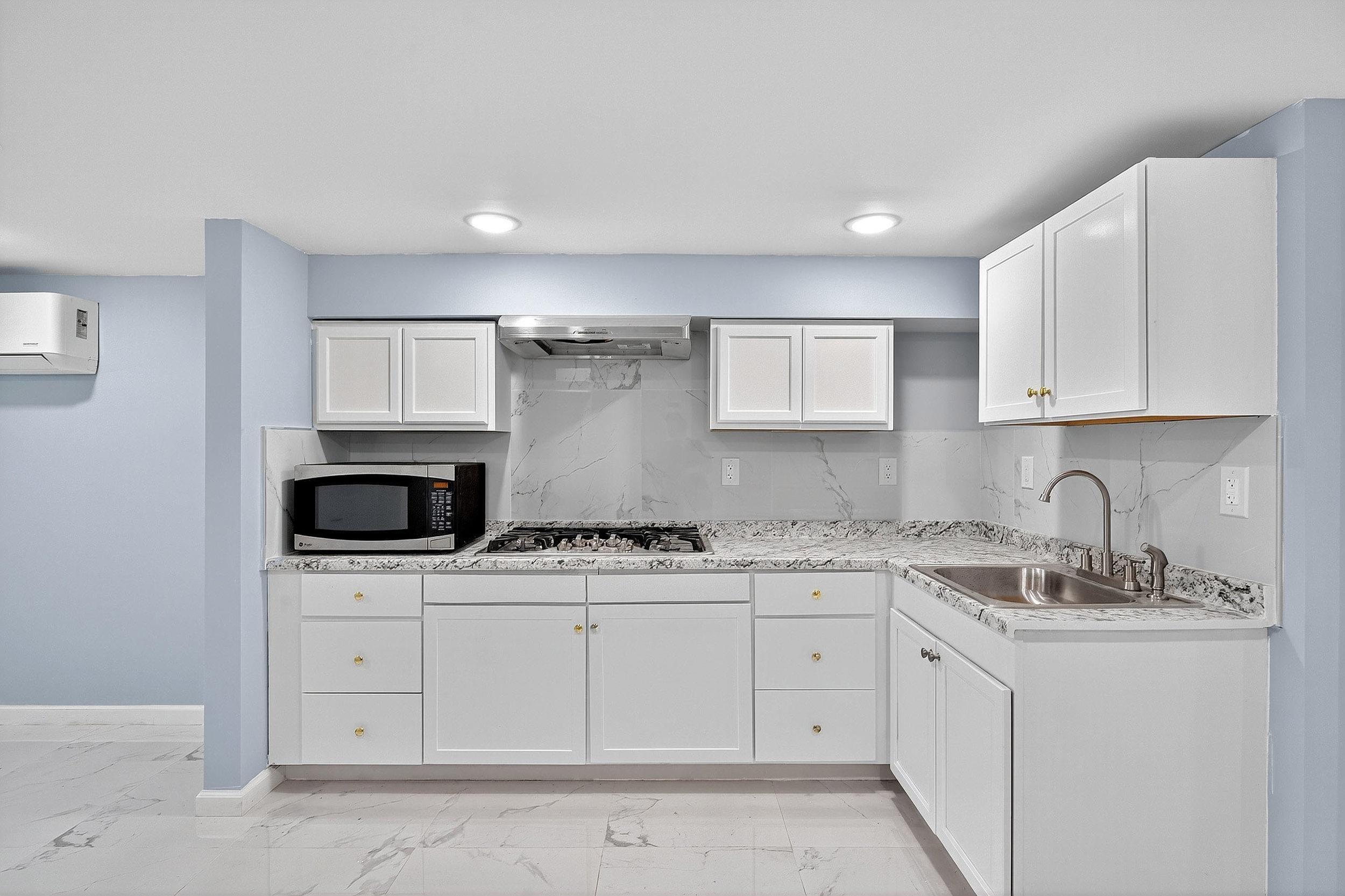 43 Sycamore Road, Unit 1 Jersey City, NJ 07305 - Photo 2 of 15 a kitchen with stainless steel appliances granite countertop a sink a stove a microwave and cabinets