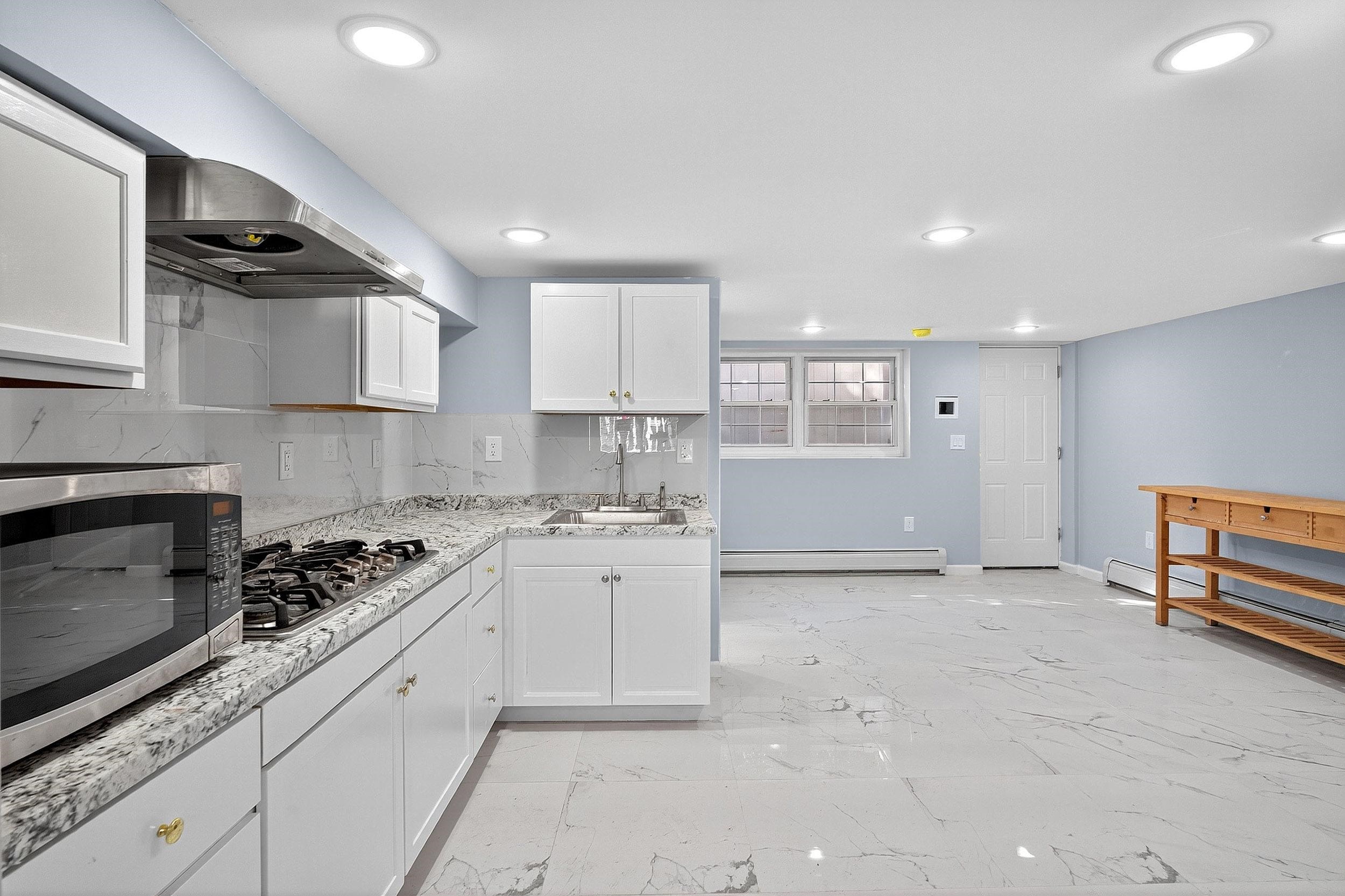 43 Sycamore Road, Unit 1 Jersey City, NJ 07305 - Photo 3 of 15 a kitchen with a stove a sink and a refrigerator