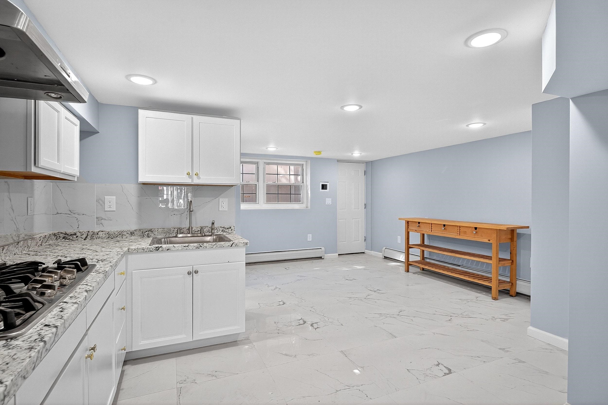 43 Sycamore Road, Unit 1 Jersey City, NJ 07305 - Photo 4 of 15 a kitchen with granite countertop a stove and a sink