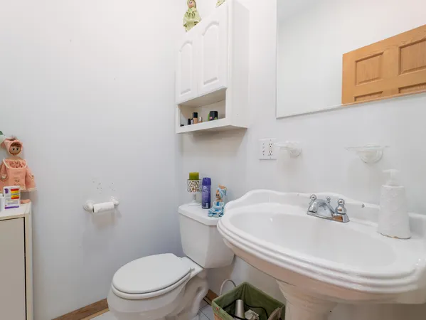 a white toilet sitting next to a bathroom sink