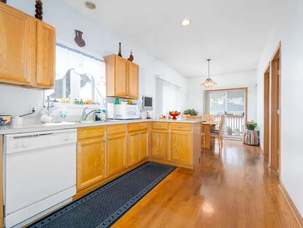 a kitchen with sink cabinets and wooden floor