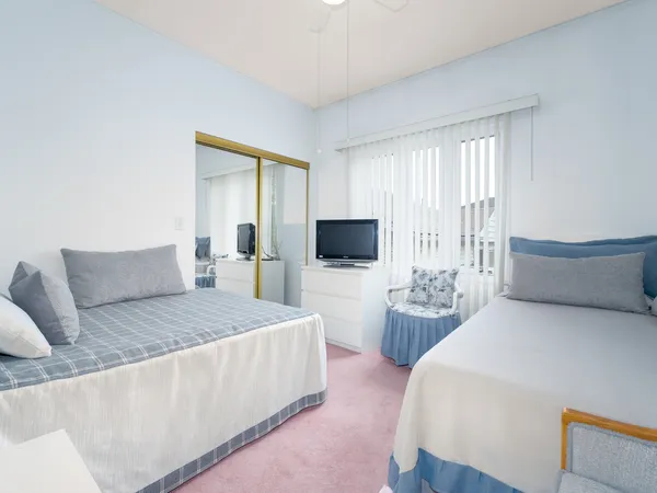 a bedroom with a bed and a flat screen tv