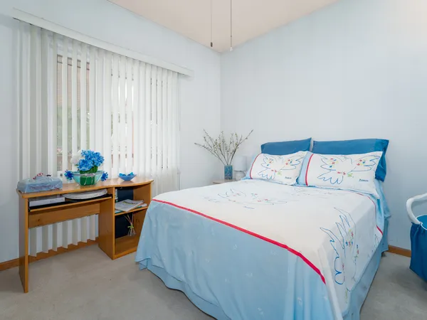 a bedroom with a bed and a table