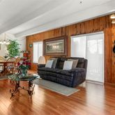 a living room with furniture a wooden floor and a window