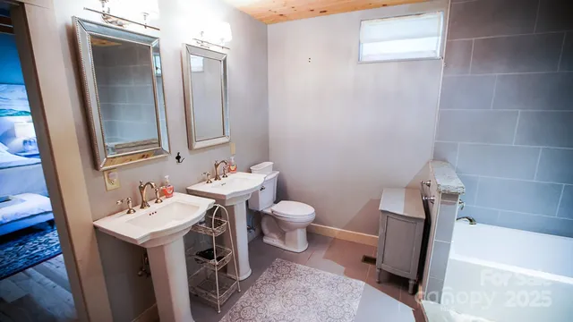 a bathroom with a sink a toilet and mirror