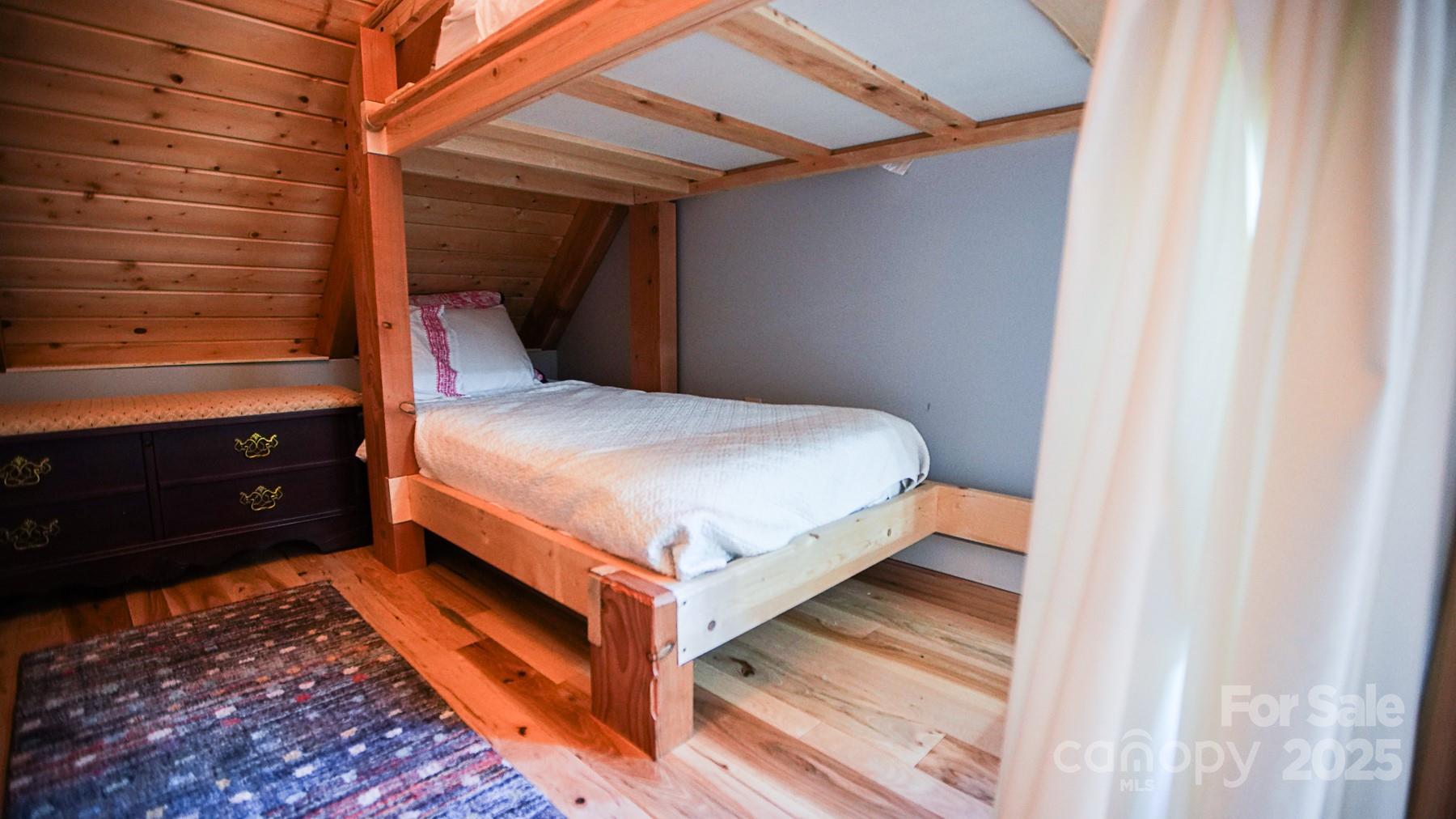 1048 South River Road Sylva, NC 28779 - Photo 20 of 42 a bed sitting in a bedroom next to a window